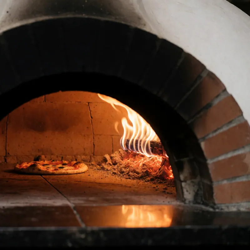 Fire against the wall of the coal-fired brick oven at Woodside Pizza, Woodside NY