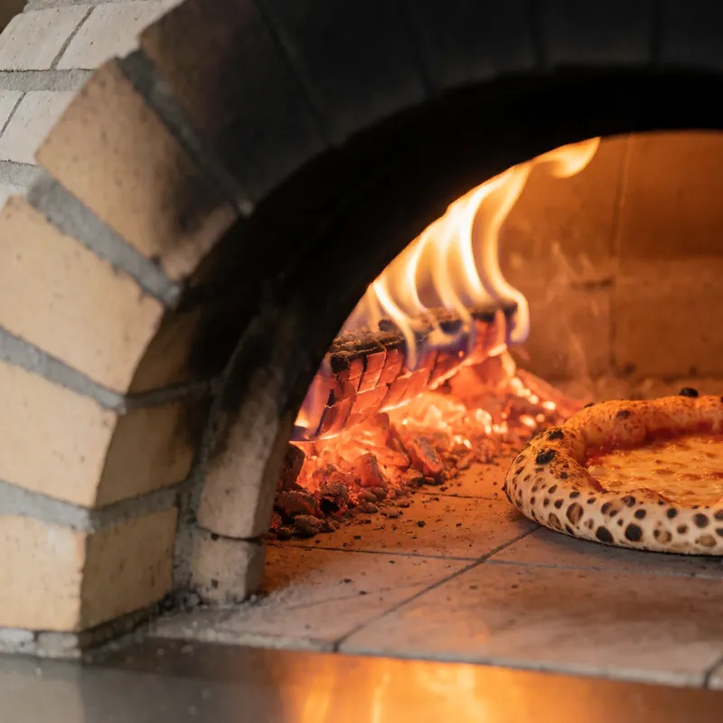 A pizza turned inside the brick oven at Woodside Pizza, Woodside NY
